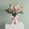 A timeless and elegant arrangement designed in soft blush and ivory tones