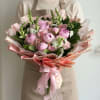 A lush mix of blush peonies, soft pink roses, and upright snapdragon