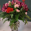 Pink and red mixed bouquet in a clear glass vase