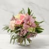 Pink and cream floral bouquet in a clear glass vase
