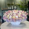 A pastel mix of peonies, roses, spray roses, lisianthus, and hydrangeas. A