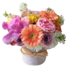 Mixed bouquet of pink, peach, and white flowers in a wrapped container