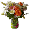 Mixed bouquet of lilies, roses, and gerbera daisies in a glass vase