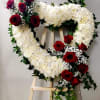 A large heart of pure white blooms edged with deep red roses