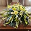 Soft blue delphinium spikes and tinted blue hydrangea set a calm, coastal