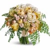 Bouquet of cream and blush roses with trailing greenery