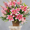Large pink-and-white lilies take center stage in this flower arrangement, creating an