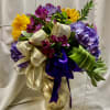 A bold celebration of color, this flower arrangement pairs lush purple hydrangeas