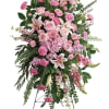 A tall, formal standing spray that reads as gentle and reverent, centered