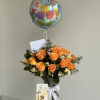 A bright yellow roses takes center stage in this flower arrangement, sending