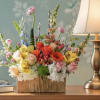 Mixed bouquet in a wooden box with roses and orchids