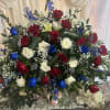 A bold spray of red, white and blue roses anchored with towering