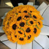 Bouquet of bright yellow sunflowers wrapped in white paper