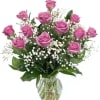 Pink roses in a glass vase with white baby's breath