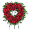 Heart-shaped wreath of red roses on a standing easel