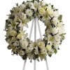 White floral wreath on a standing easel