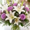 Graceful and timeless, Lavender Elegance showcases fragrant white lilies paired with luxurious