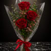 Three deep red roses stand upright at the heart of this romantic