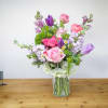 Mixed pink and purple bouquet in a clear glass vase