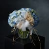 Blue and white hydrangea bouquet tied with a sheer ribbon
