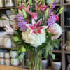 A stunning tall and airy arrangement featuring a graceful blend of roses