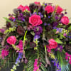 A stunning casket piece created in warm plumb colors. Spectacular