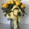 Yellow roses in a silver vase with a large gingham ribbon