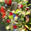 Large patriotic floral wreath with roses, lilies, and American flags