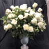 White rose arrangement in a silver pedestal vase