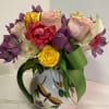 Bouquet of mixed roses and tulips in a decorative mug vase