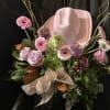 Pink and lavender bouquet with a pink cowboy hat and glittery ribbon