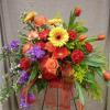 Colorful standing floral arrangement with roses, gerbera daisies, tulips, and ribbon
