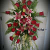 Red roses, Stargazer Lilies and White Larkspur create this loving tribute. This