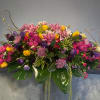 A lush, low-spread sympathy arrangement that reads like a joyful celebration of