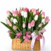 A charming basket arrangement featuring a lush mix of pink and white