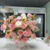 Soft pink and white roses, ranunculus, carnations and lilies with sunny yellow
