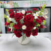 Deep red roses with white tulips and green accents in a white