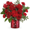 Red roses and carnations in a heart-patterned red vase