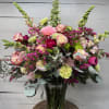 Mixed pink and cream bouquet in a clear glass vase