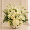 This elegant composition features lush white hydrangeas, creamy ivory roses, graceful white