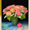 Pink and peach peonies arranged in a glass vase
