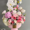 An exquisite arrangement featuring graceful white orchids, lush pink peonies, premium garden