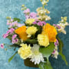 Bright yellow roses take center stage in this springlike flower arrangement, making