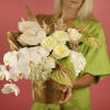 White orchid and rose arrangement in a gold container
