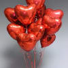 Cluster of red heart-shaped balloons on strings