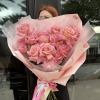 Large bouquet of pink roses wrapped in pale pink paper