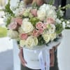 Bouquet of pink and white roses in a white hat box