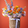 Bright orange gerbera daisies and ranunculus set the tone in this Sunset