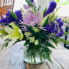 Pastel Elegance Bouquet features a mix of purple and white flowers. 
(vase