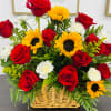 Basket arrangement of red roses, sunflowers, and white carnations
